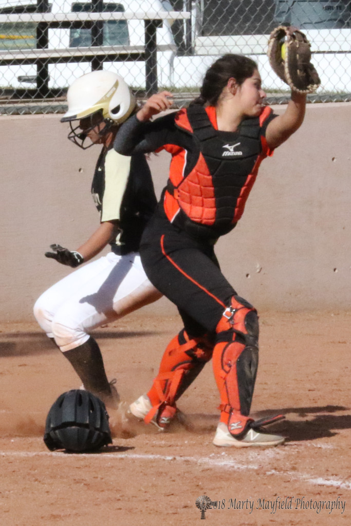 its a race to the plate as Natausha Ortega just beats the ball and escapes the tag by Taos catcher Ariana Aguilar Tuesday afternoon 