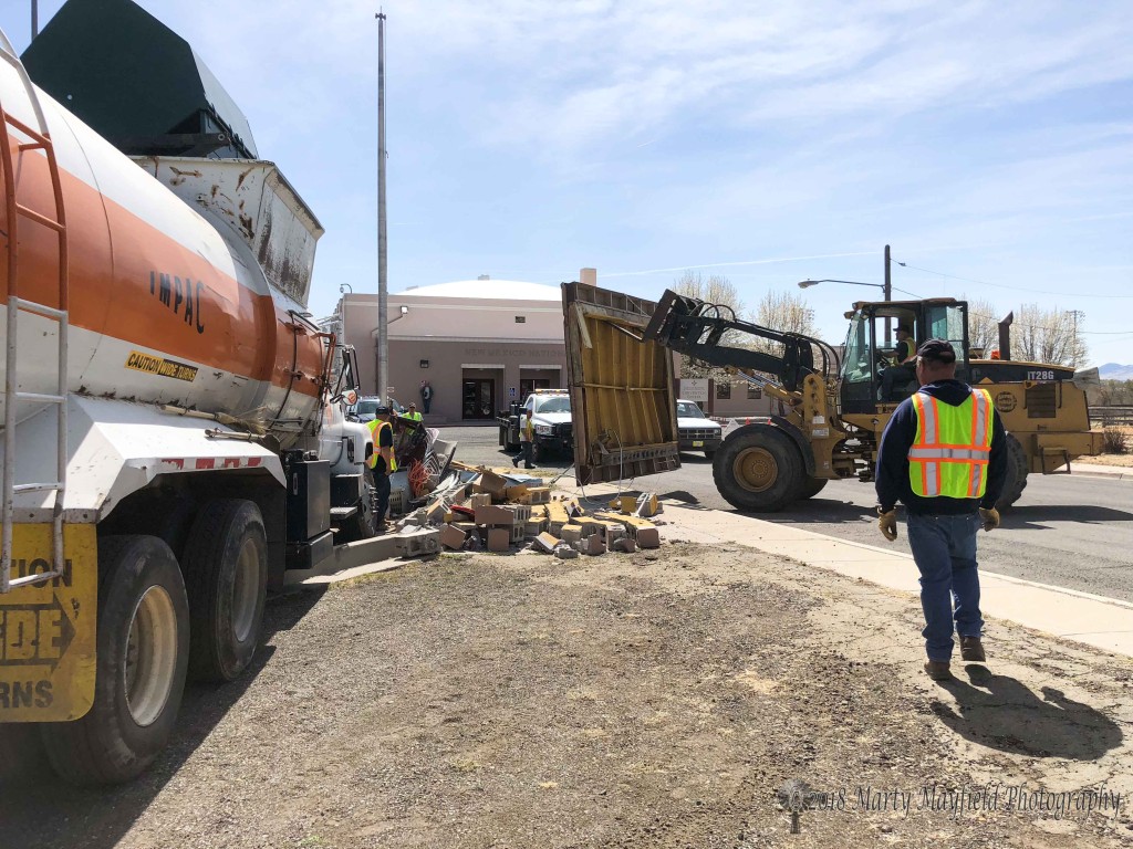 Raton City Crews begin the work of cleaning up the debris from the announcer's booth at Gabrielle Field after a Raton City trash truck demolished Tuesday morning.